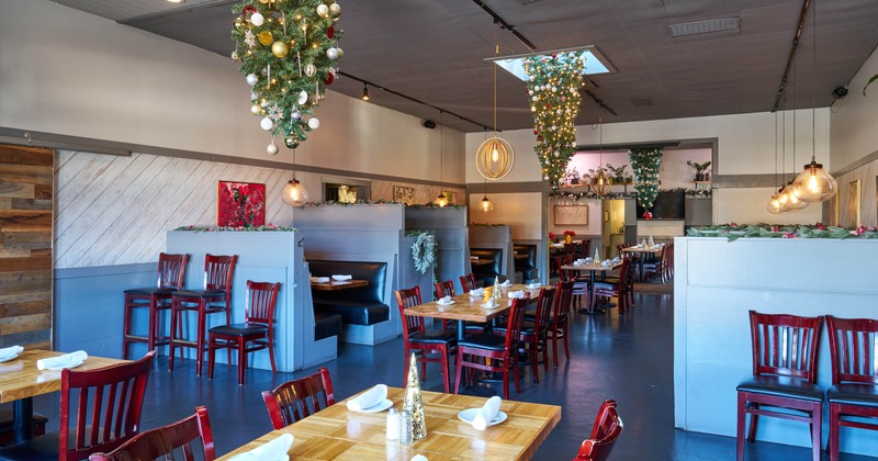 Restaurant interior with inverted Christmas trees hanging from the ceiling and festive decorations