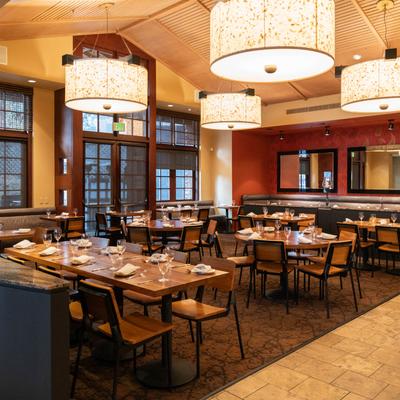 Interior, dining area with  set tables ready to receive guests.