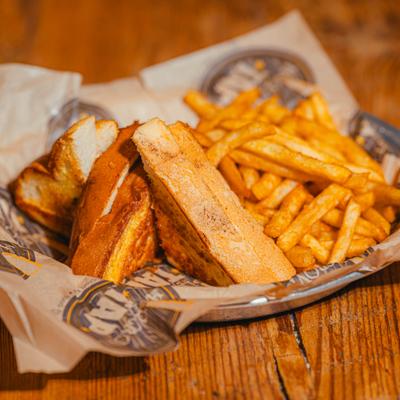 Grilled cheese sandwich served with fries.