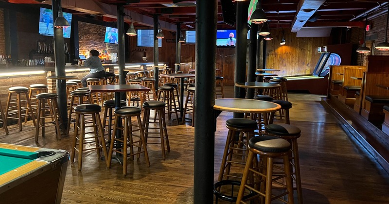 Interior, high tables and chairs near pool table