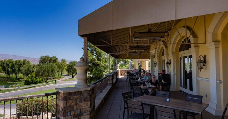 Exterior, guests sitting at tables on a terrace