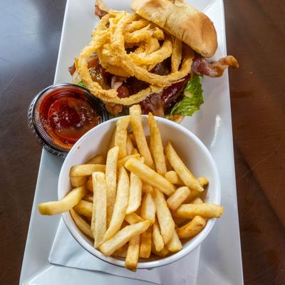 BBQ Burger topped with bacon and onion rings, served with fries and a dip.