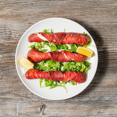 Air dried beef, thinly sliced and rolled, filled with arugula and ricotta cheese.