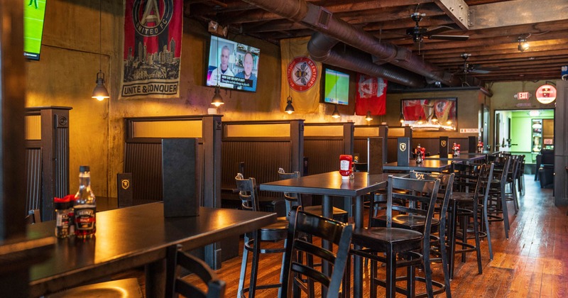 Interior, seating area, high seating tables with chairs, divided seating booths in the back