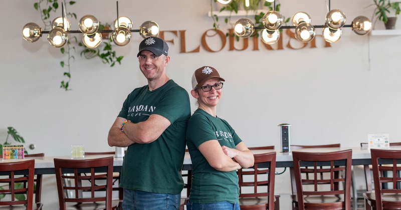 Two staff members posing with arms crossed