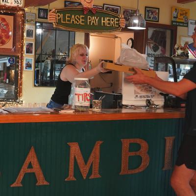 Staff member serving a customer at the counter.