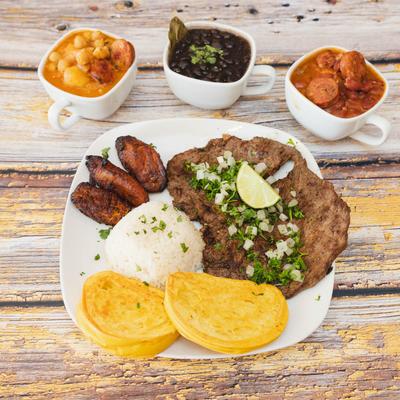 Grilled steak, rice, plantains, and corn dough.