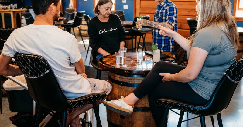 Staff member serving cocktail to the guests seated at the high table