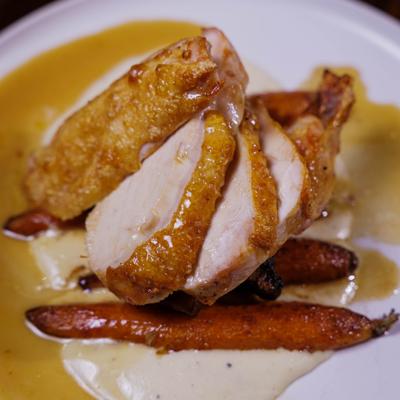 Roasted Amish chicken served over parsnip purée with roasted carrots and pan jus