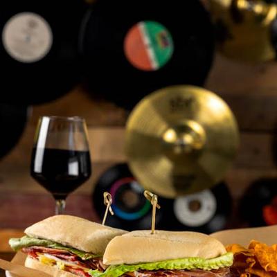 The Sully sandwich with cured Italian meats, served with a glass of red wine.