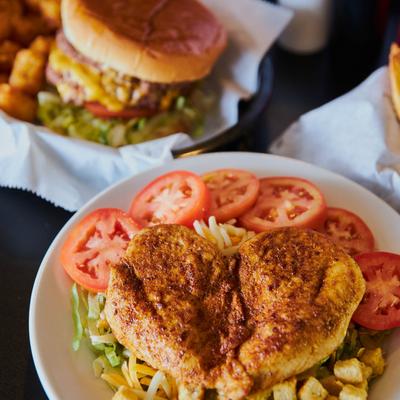 Chicken Salad with lettuce, tomato, cheese, bacon, and pickles.