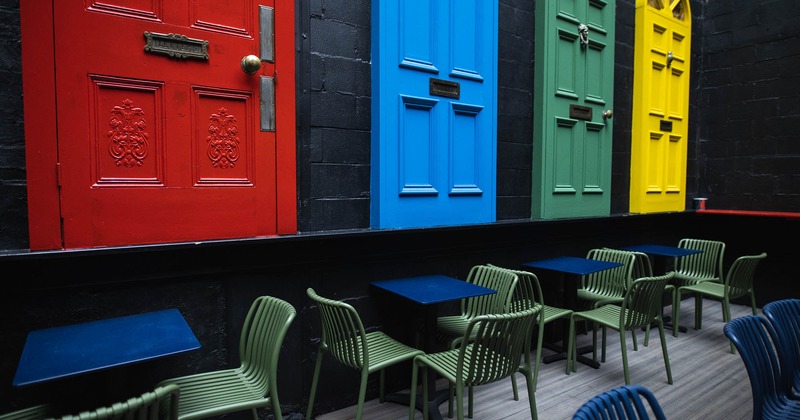 Exterior, patio, tables and chairs, interesting decoration on the wall