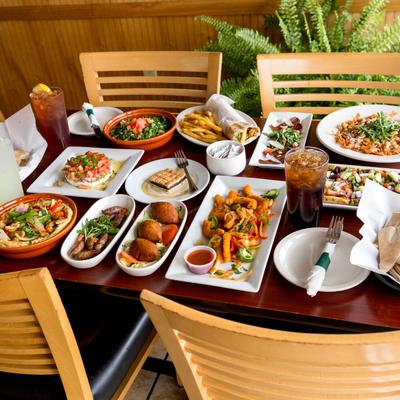 A table spread with assorted dishes and drinks.
