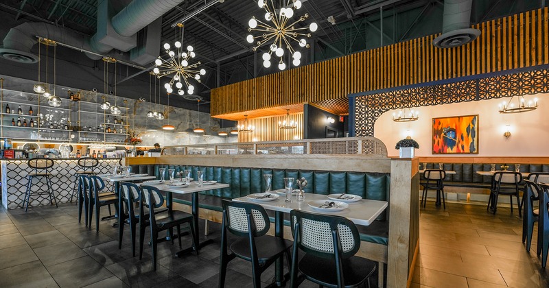 Interior, dining area with set tables and bar