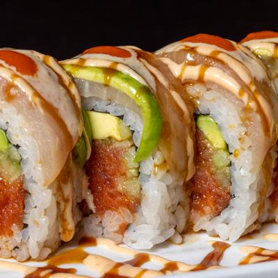 Jay roll with tuna, cucumber, and avocado, drizzled with sauce.