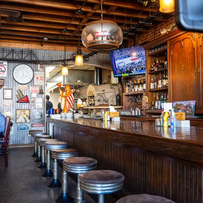 Bar, chairs, drink rack, side view.