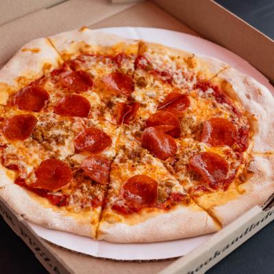 Pepperoni and sausage pizza in a box.