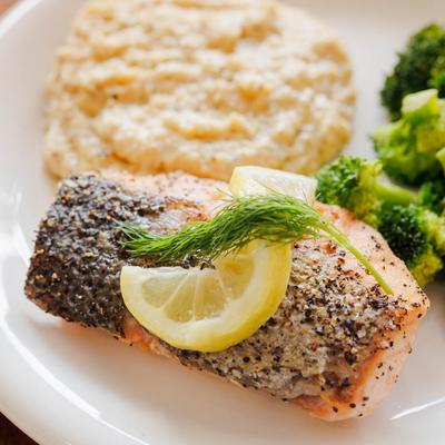 Blackened salmon with grits, closeup.