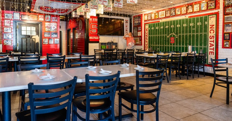 Interior of a sports-themed restaurant with NC State memorabilia and decorations