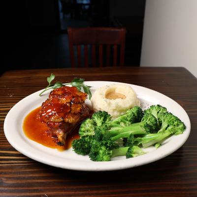 Pork Chop with apricot glaze  with mashed potatoes and broccoli.