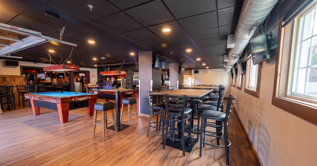 Interior, high seating tables with stools, billiards tables, TV sets on the walls