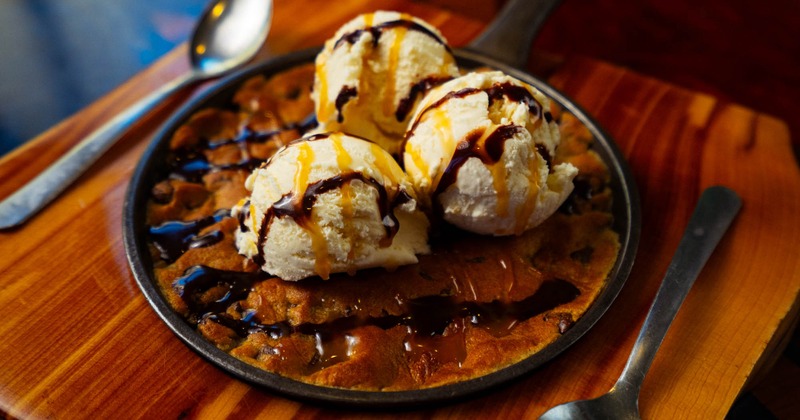 Cookie skillet topped with three ice cream scoops