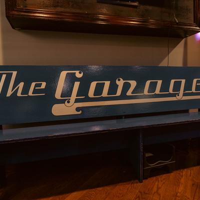 Wooden bench with the bar logo.