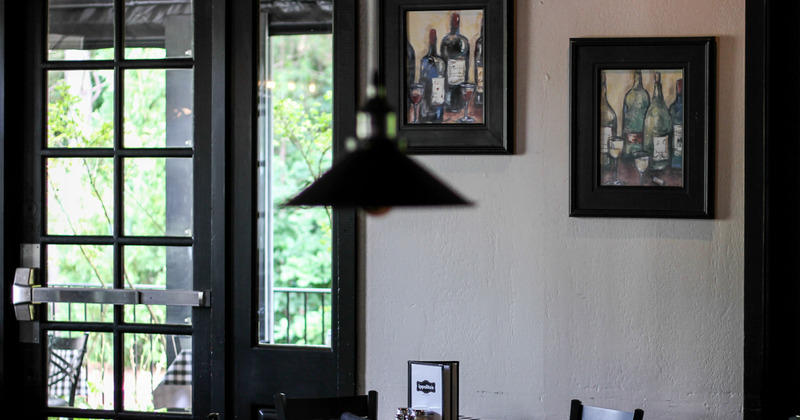 Interior, paintings of wine bottles on wall