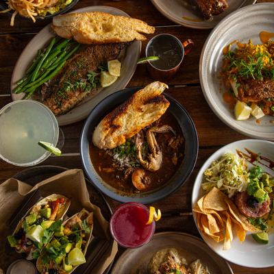 Assortment of dishes and cocktail drinks, top view.