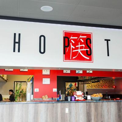 Interior, food counter with Chopstix sign.