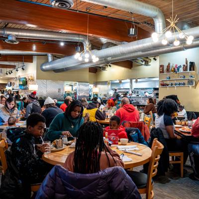 Busy restaurant dining room with guests eating.