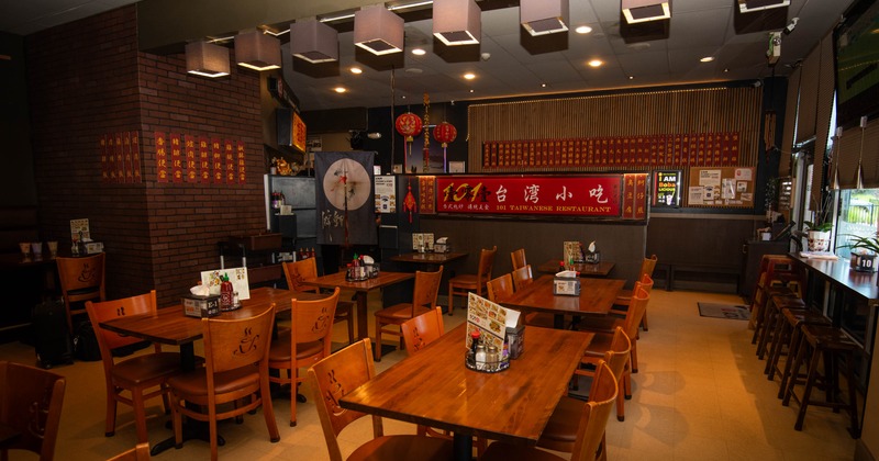 Interior, wooden tables and chairs, red banners on the walls, and decorative elements