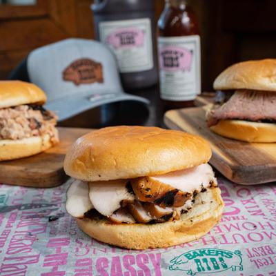 Pulled pork, Smoked turkey, and brisket sandwiches on soft buns.