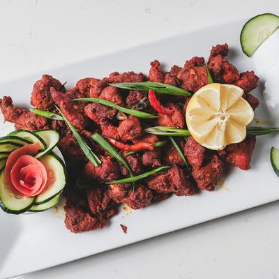 Marinated fried chicken, with curry leaves and mustard seeds.