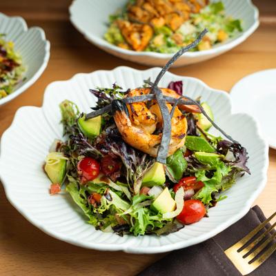 Grilled shrimp salad with mixed greens, tomatoes, avocado, tortilla strips, and balsamic.