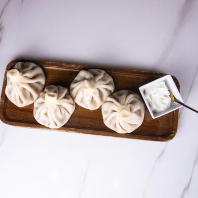 Khinkali Georgian dumplings served with a sauce.