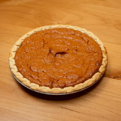 Sweet Potato Pie sits on a wooden table.