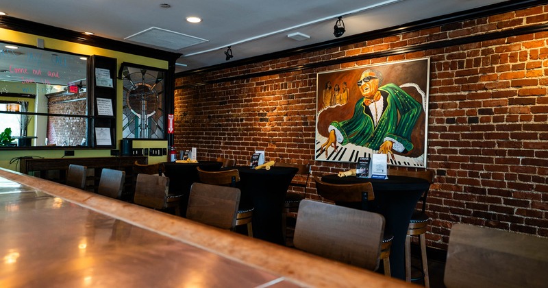 Bar area with bar stools, big painting on the wall