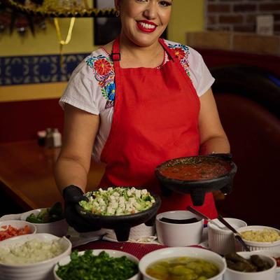 An employee with prepared salsas