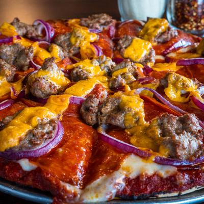 The Sharp Dressed Man Pizza with pepperoni, sausage, red onion and and strips of cheddar.