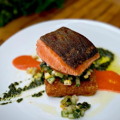 Seared salmon with crispy polenta and vegetables.