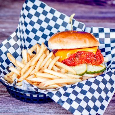 Hot Cheeto coated fried chicken sandwich and fries.