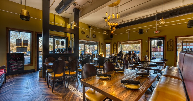 Interior, dining area with leather benches and chandeliers