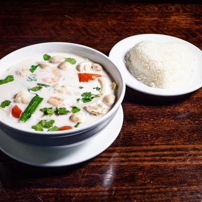 Tom Kha Soup with coconut milk, mushroom, tomato, onion and cilantro
