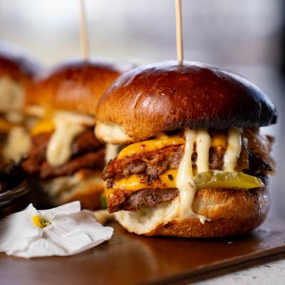Sliders featuring double beef patties topped with melted cheese.