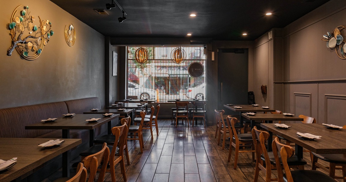 Cozy restaurant interior with wooden tables, banquette seating and chairs