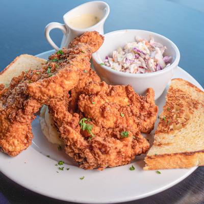 Fried chicken served with bread and mixed salad
