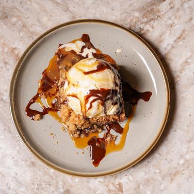 Sea Salt Caramel Brownie topped with ice cream.