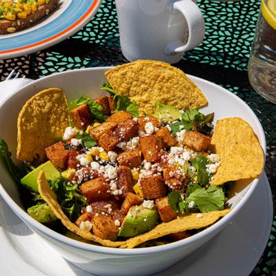 Snacks, mixed vegetables, baked potato and cheese on top
