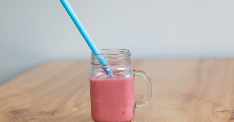 Rockin Red smoothie served in a jar with a straw